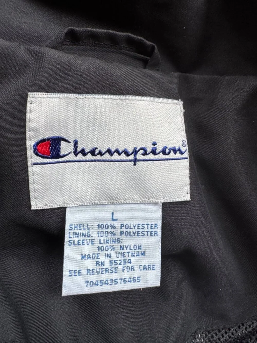 vintage Champion windbreaker jacket featuring a black body with a white chest st